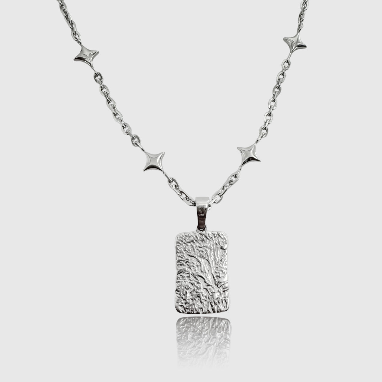Silver star chain necklace with lava stone pendant – grounding volcanic gemstone jewelry.