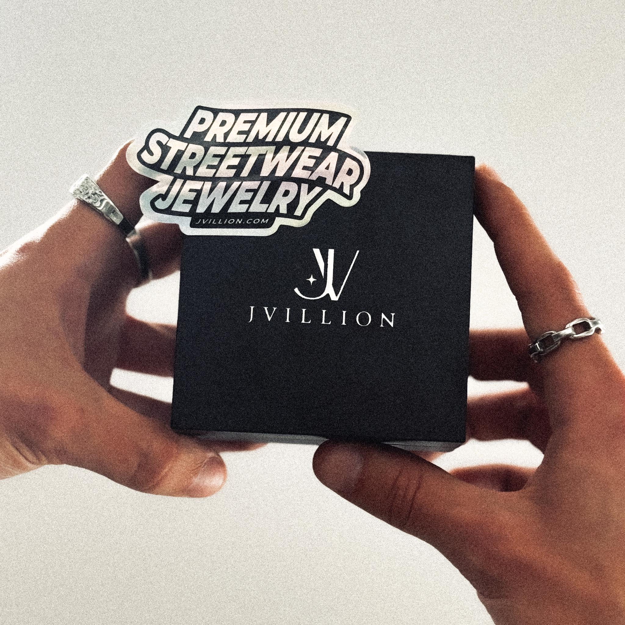 Black JVillion jewelry gift box held in hands, premium streetwear packaging