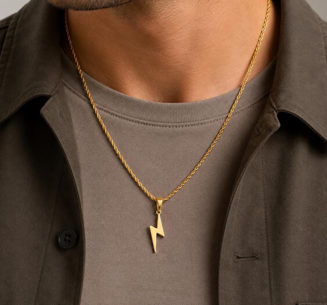 Gold flash lightning bolt pendant on 2mm rope chain worn by model, JVillion