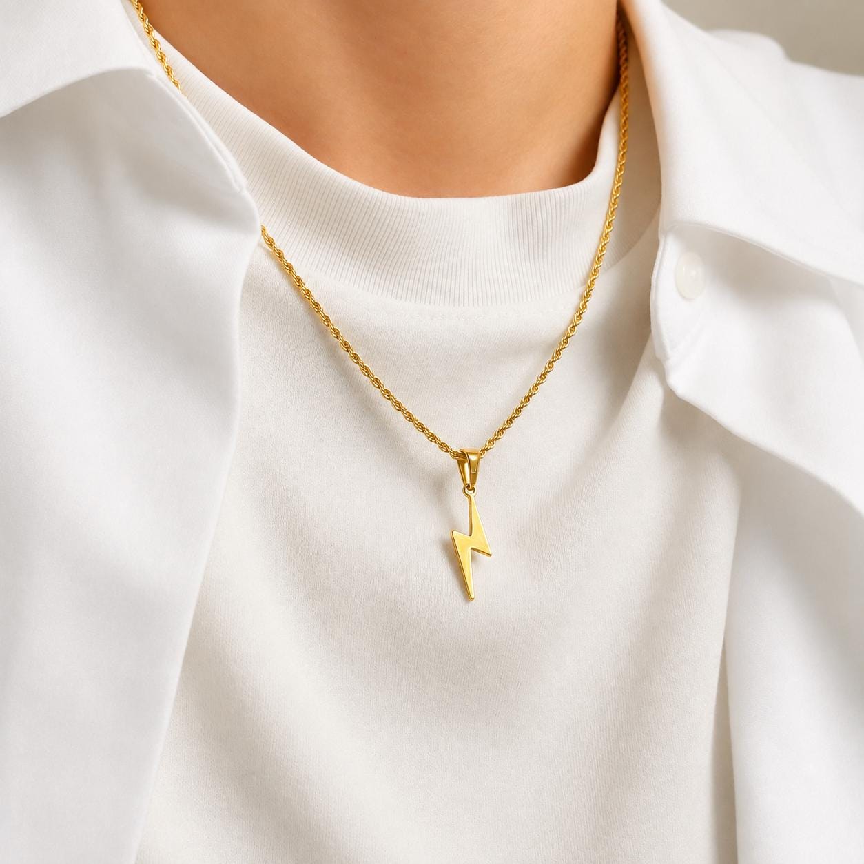 Gold flash lightning bolt pendant on 2mm rope chain on fabric, JVillion