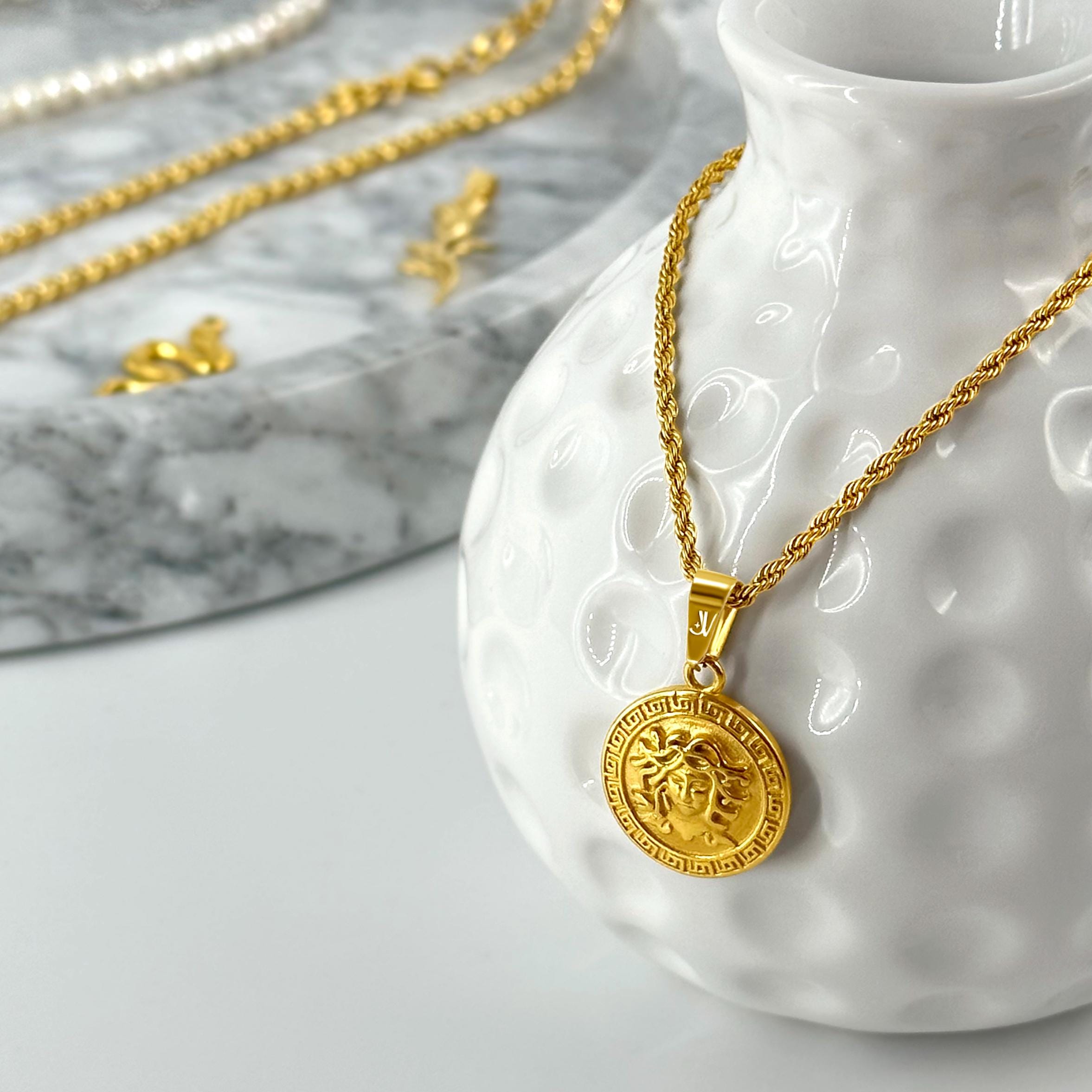 Gold Medusa medallion pendant on 2mm rope chain, styled product scene, JVillion