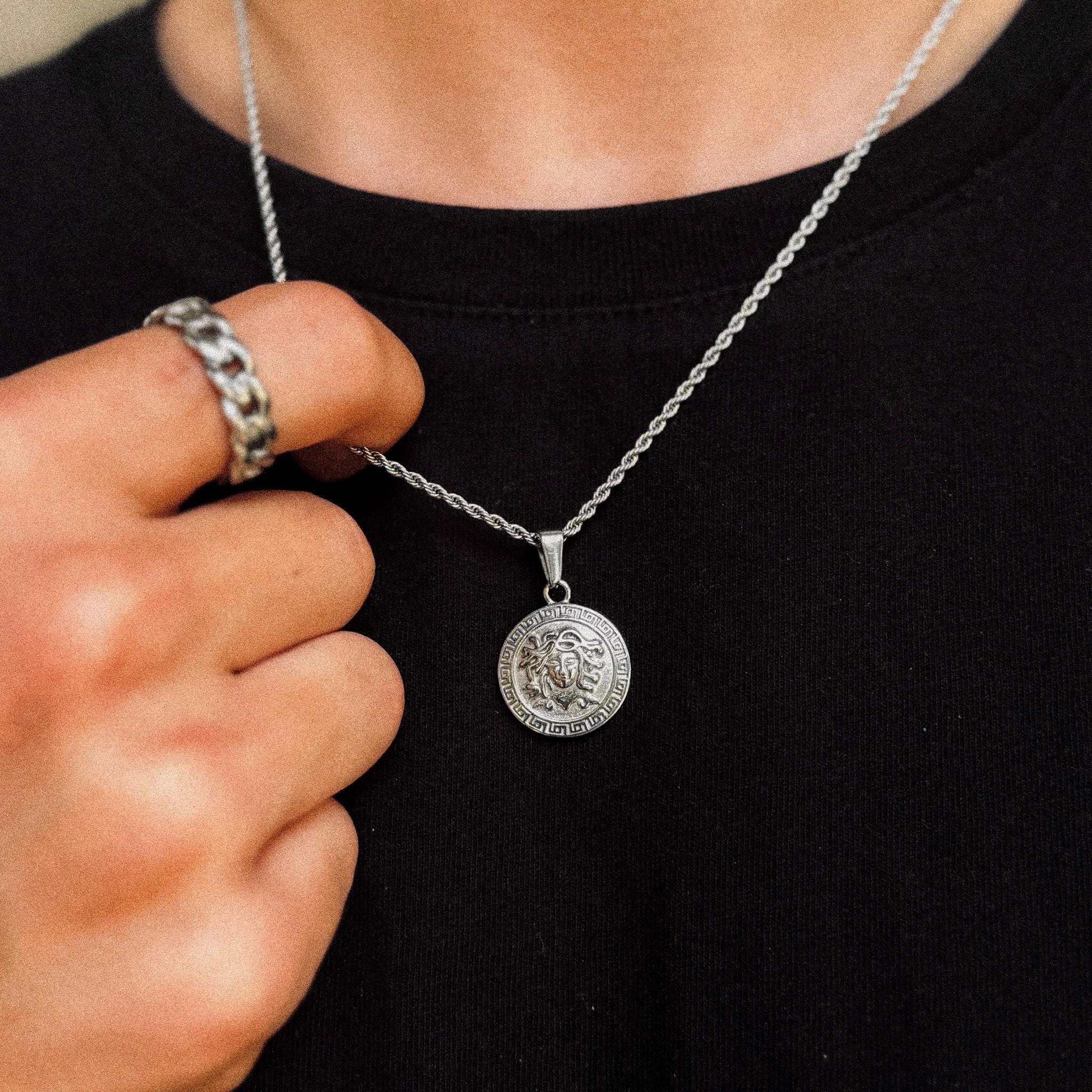 Silver Medusa medallion pendant on 2mm rope chain held to camera, JVillion