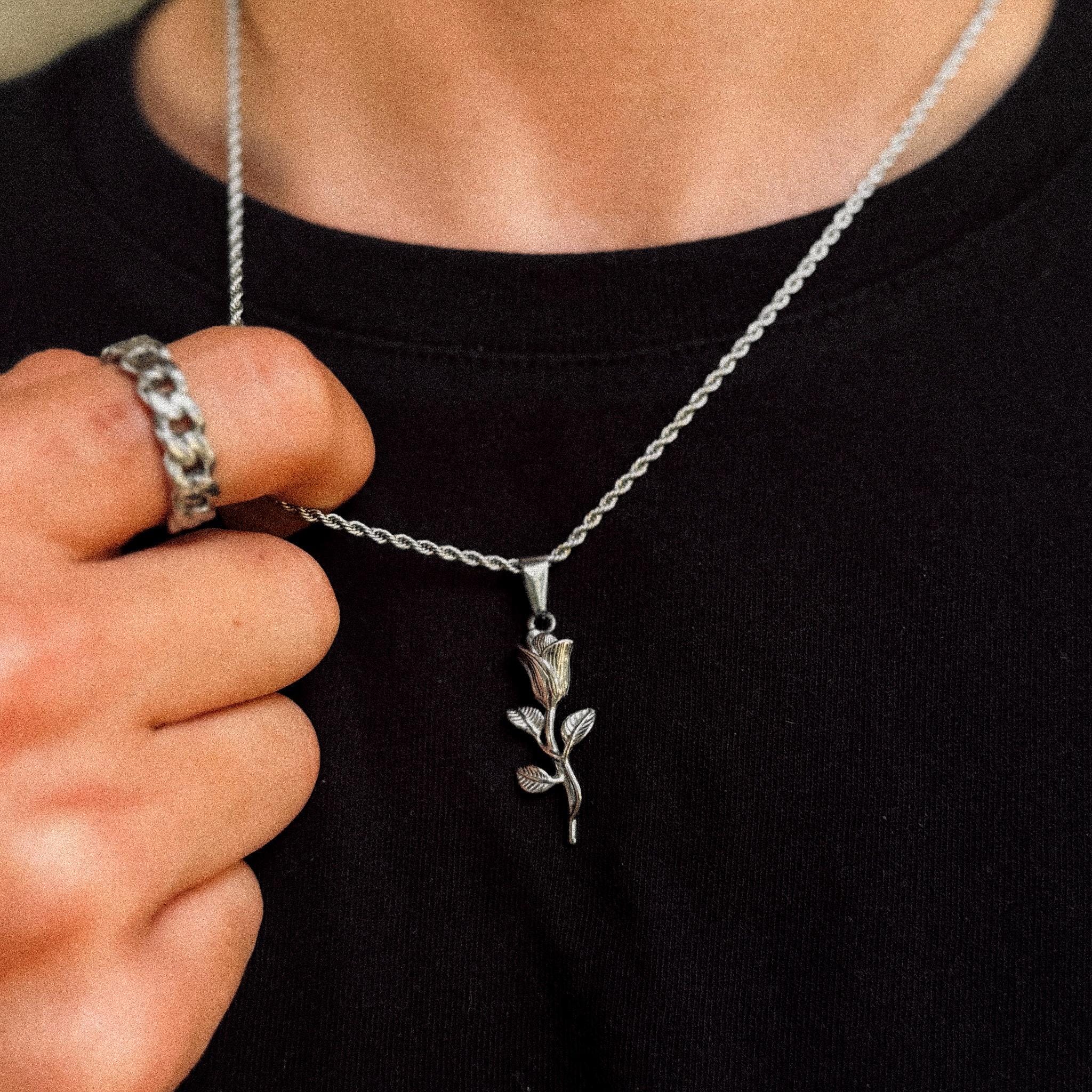 Silver rose flower pendant on 2mm rope chain held to camera, JVillion