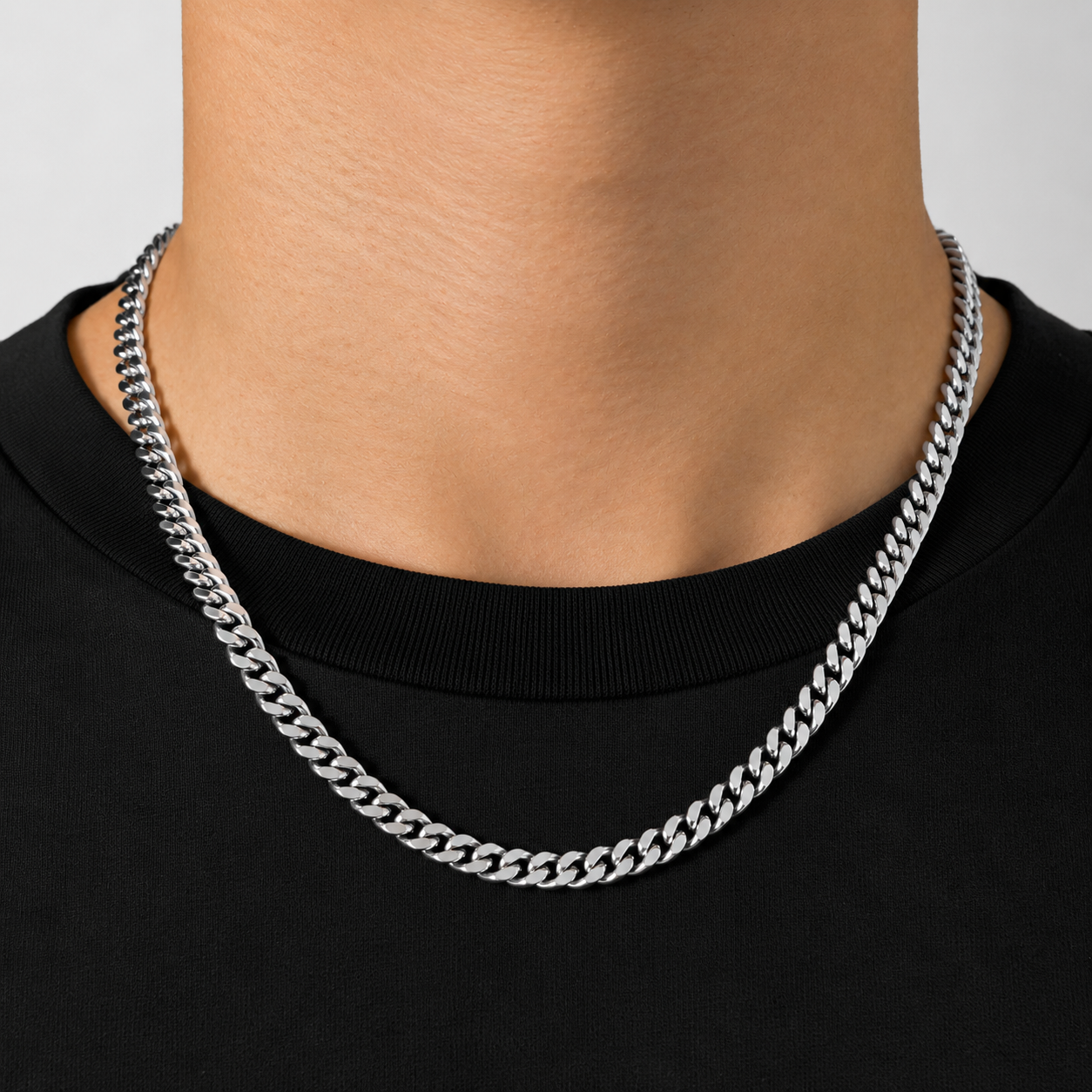 Model wearing silver 6mm Cuban link chain necklace, black tee, JVillion