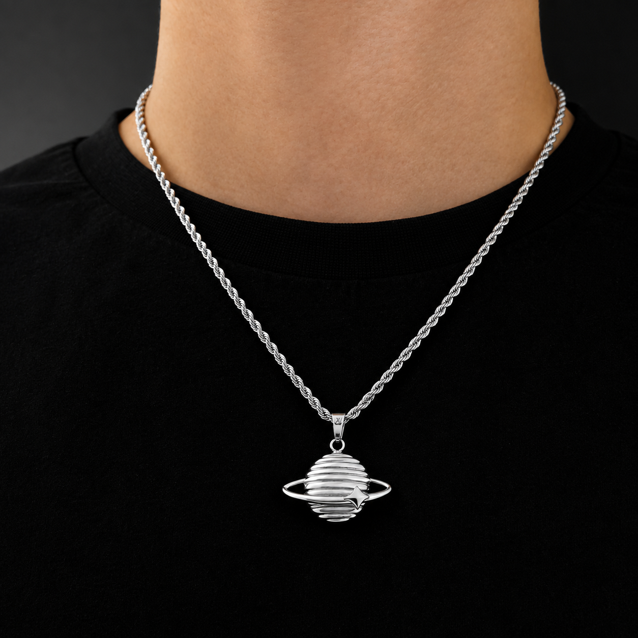 Model wearing a silver Saturn planet pendant on a 3mm rope chain, black tee, JVillion