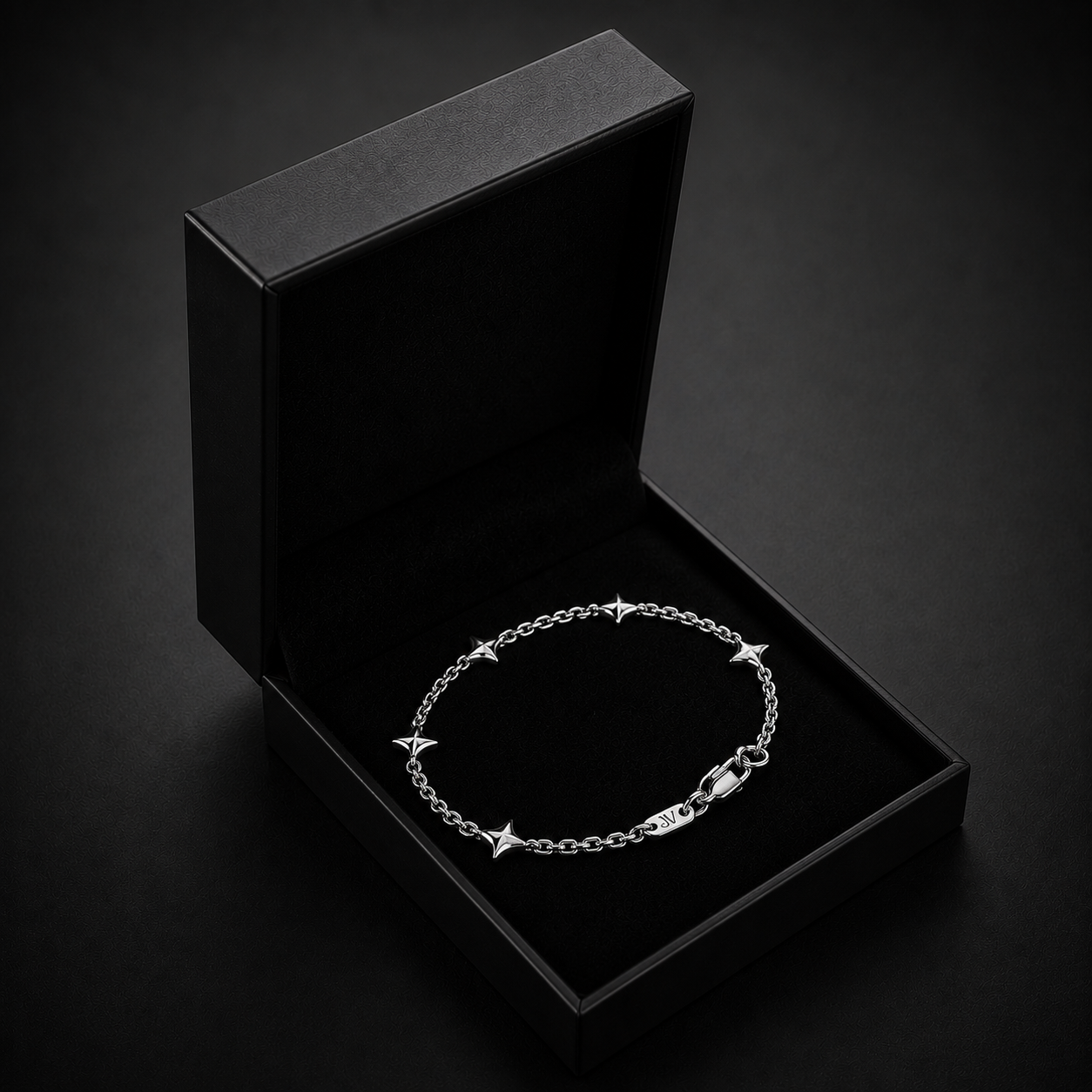 Pulseira de elos estrela prateada numa caixa de oferta preta JVillion